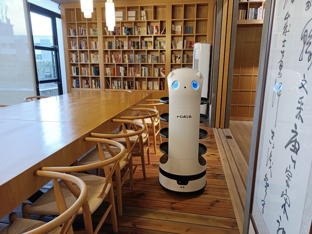 white and black amazon echo dot on brown wooden table