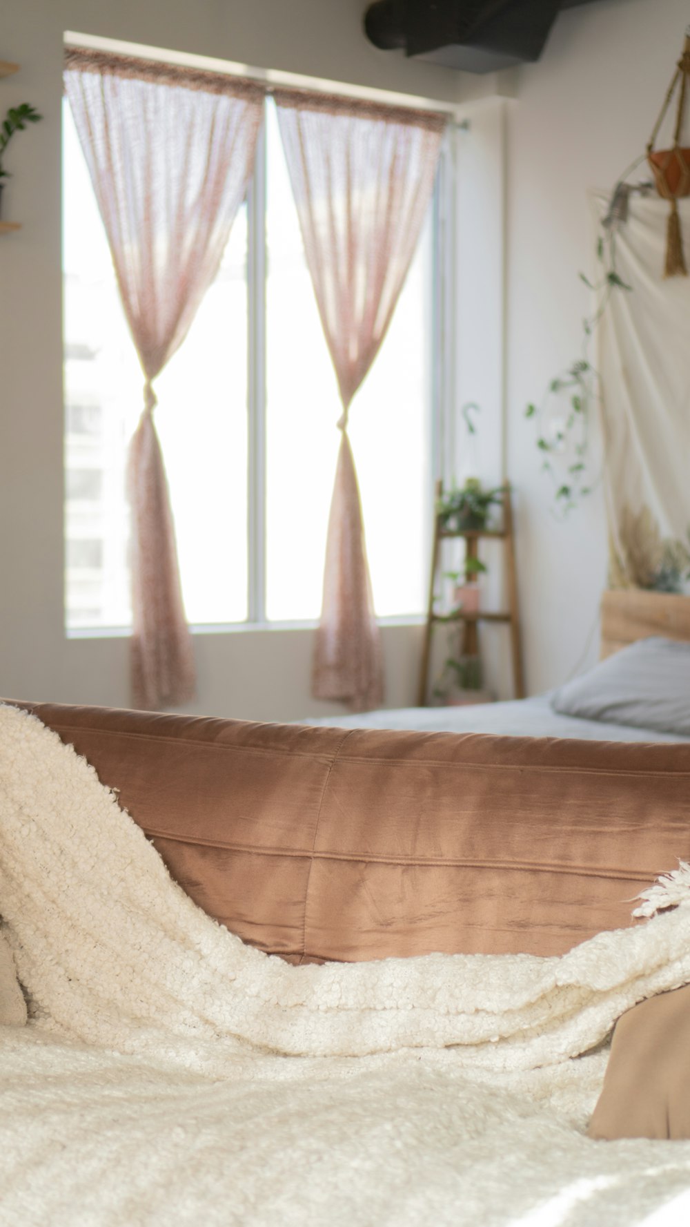 white textile on brown bed