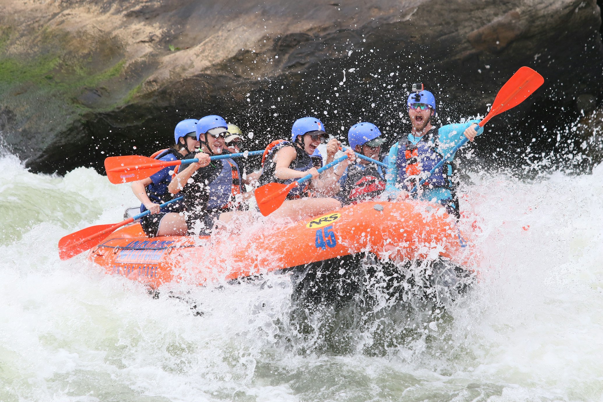 a group of people doing white-water rafting