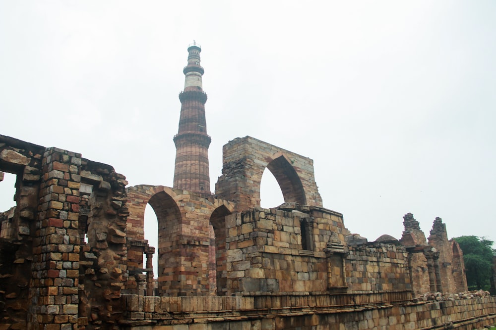 an old brick building with a tower in the background