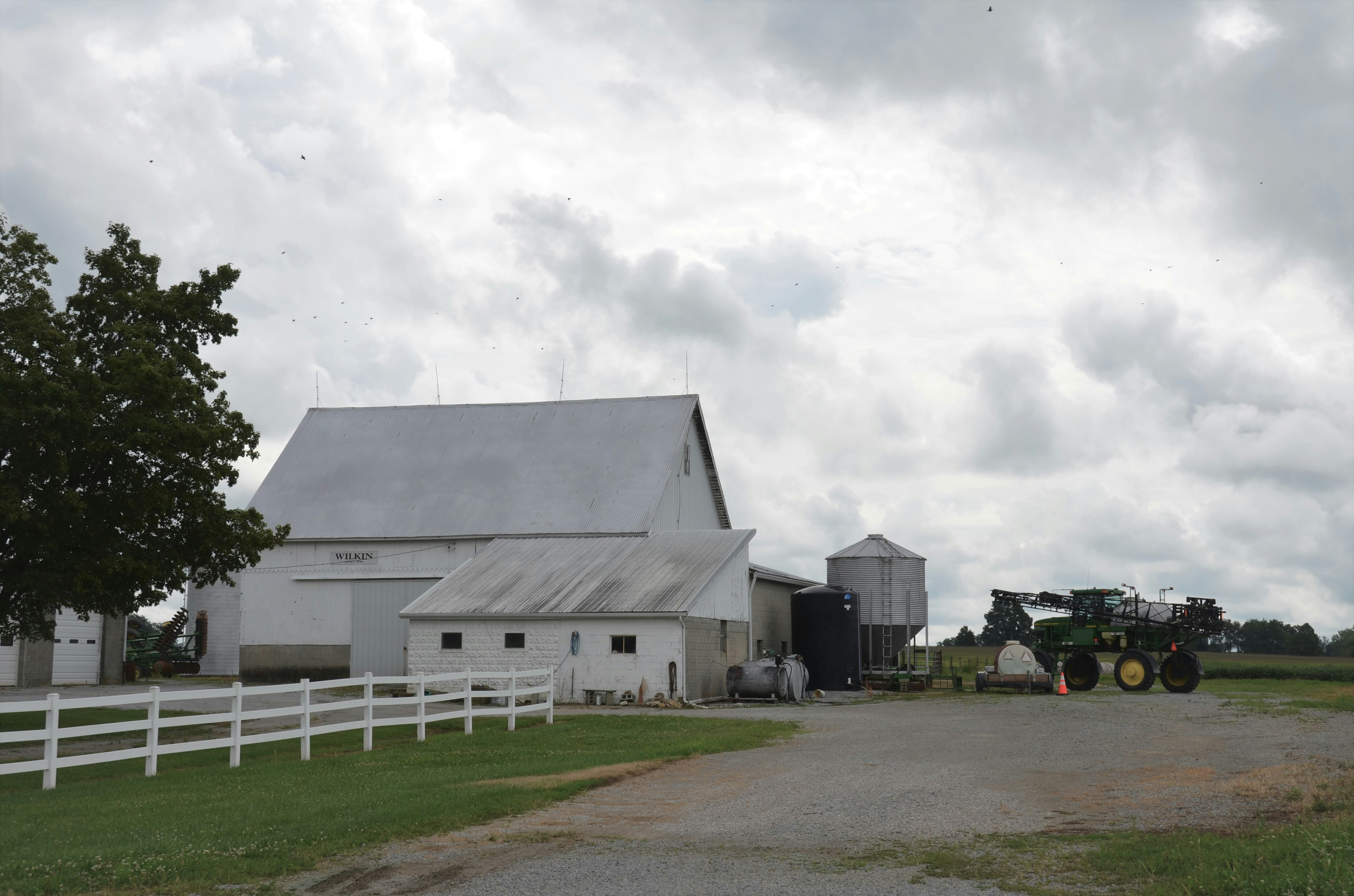 white and gray house under white clouds during daytime