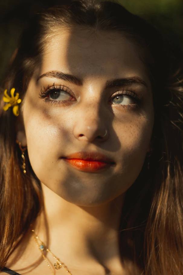 woman with yellow flower on her ear