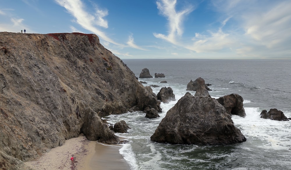 brown rock formation on sea shore during daytime