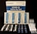 A COVID-19 Saliva Antigen Test Kit includes test cards, pipettes, swabs, and sample tubes arranged on a dark surface. The packaging is prominently displayed at the top.