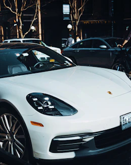 white porsche 911 parked on street during daytime