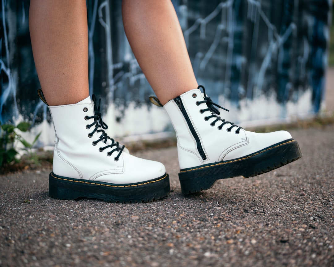 person wearing black and white high top sneakers