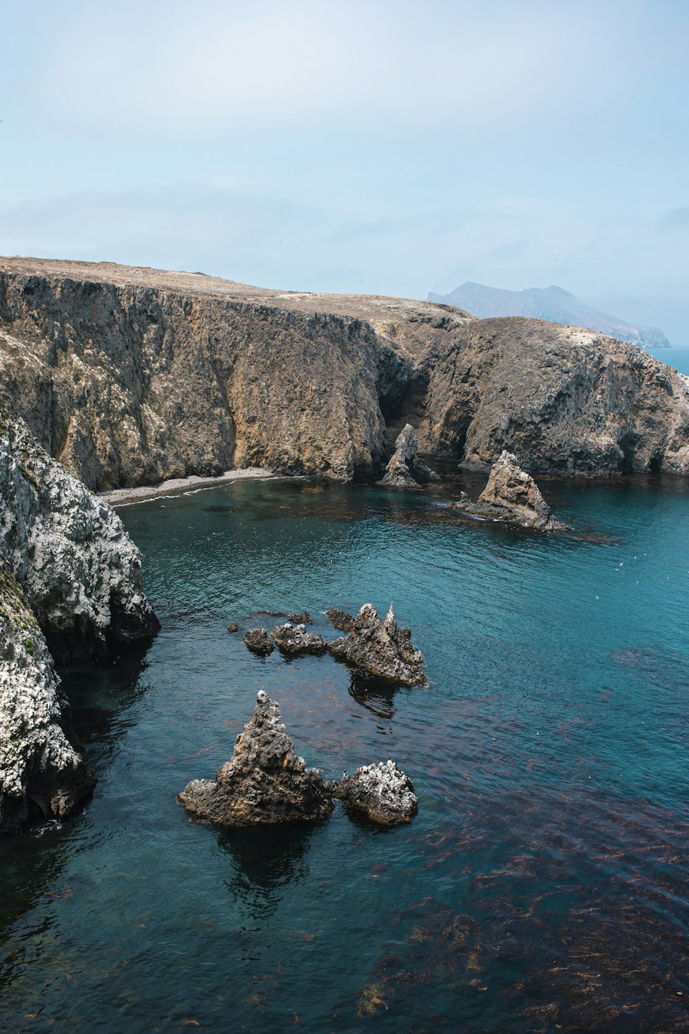 brown rock formation on blue sea during daytime