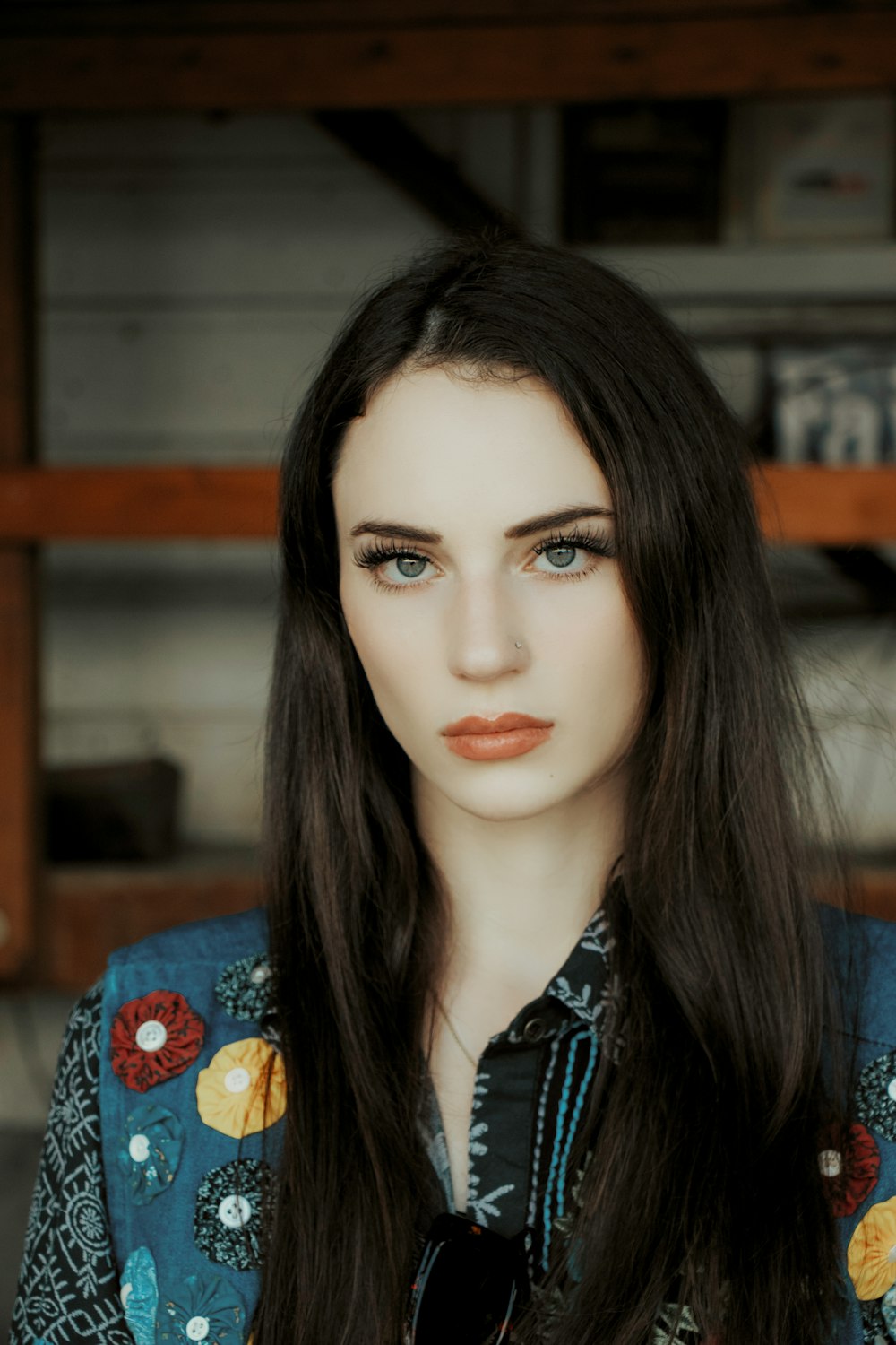 woman in blue and red floral shirt