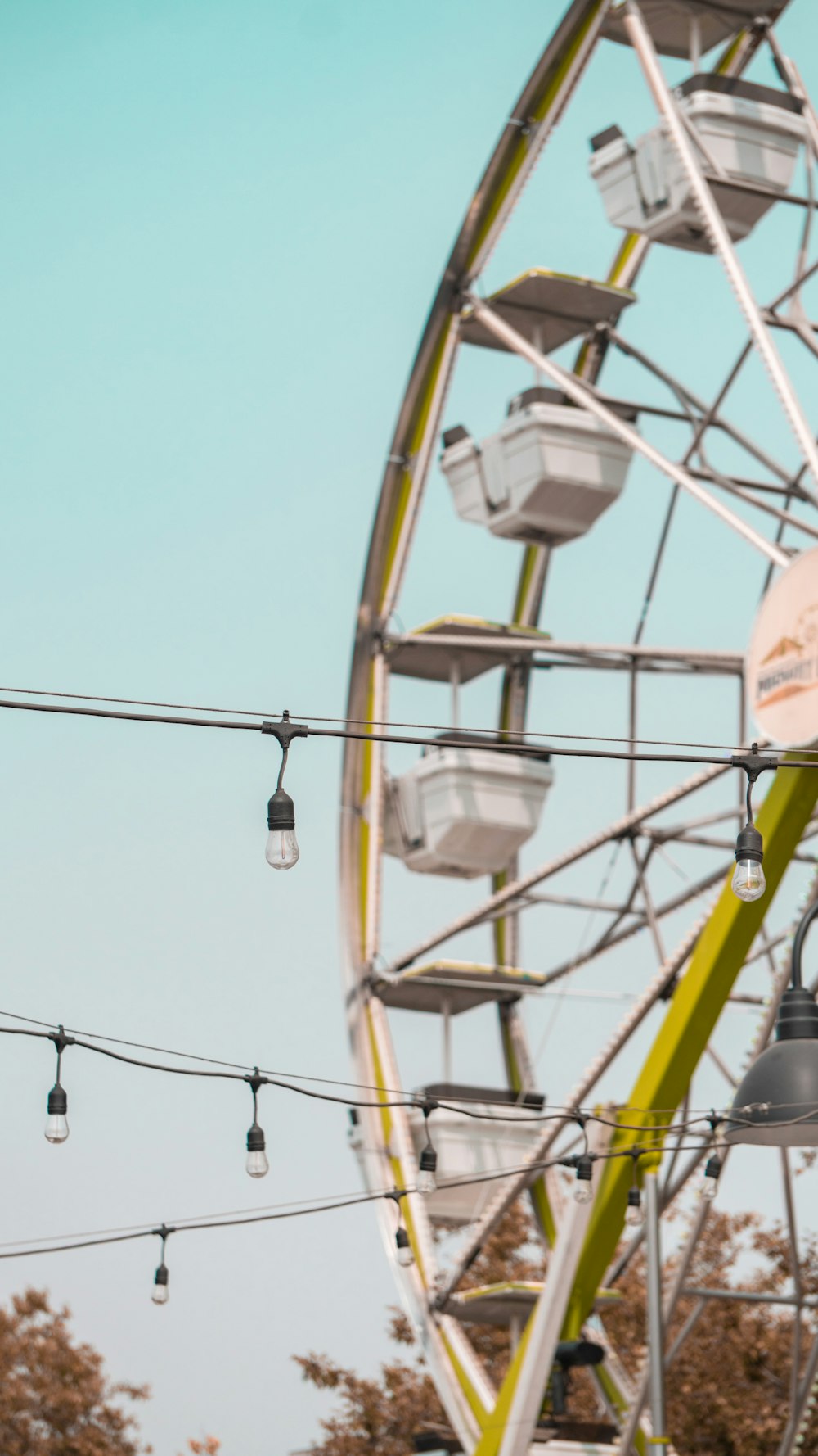 yellow and white ferris wheel under blue sky during daytime