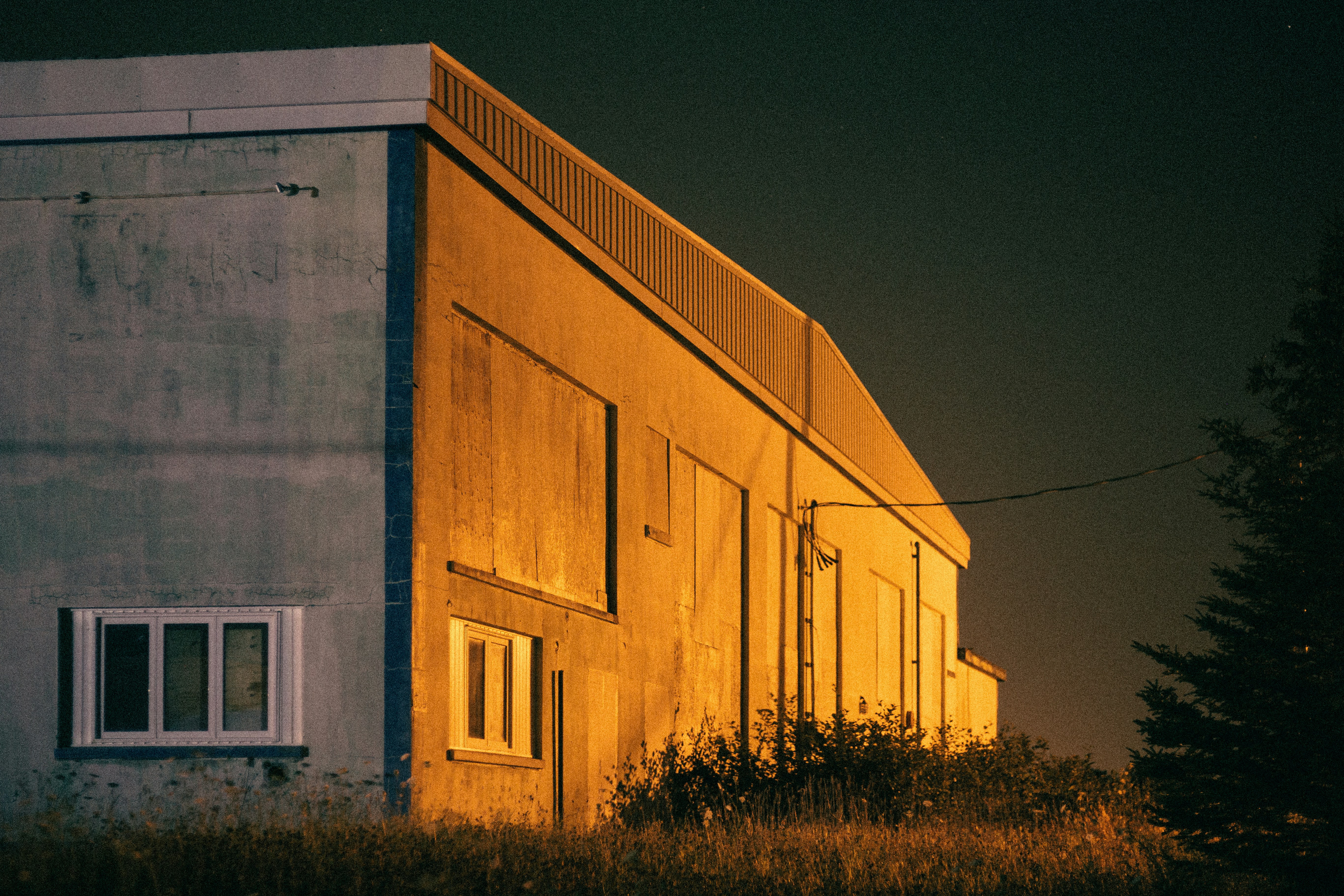 Brown wooden house surrounded by green grass
