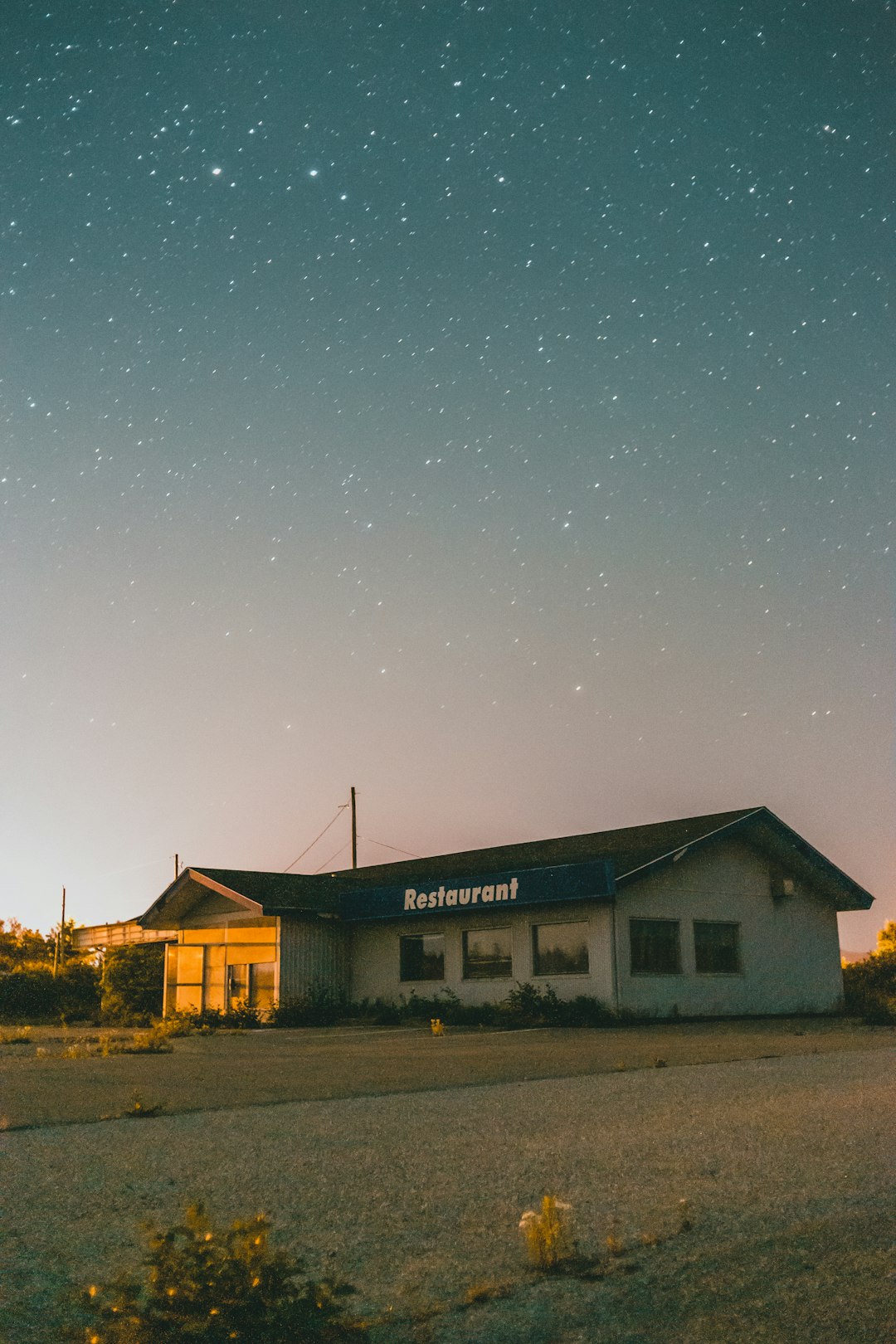 white and gray house under blue sky during night time