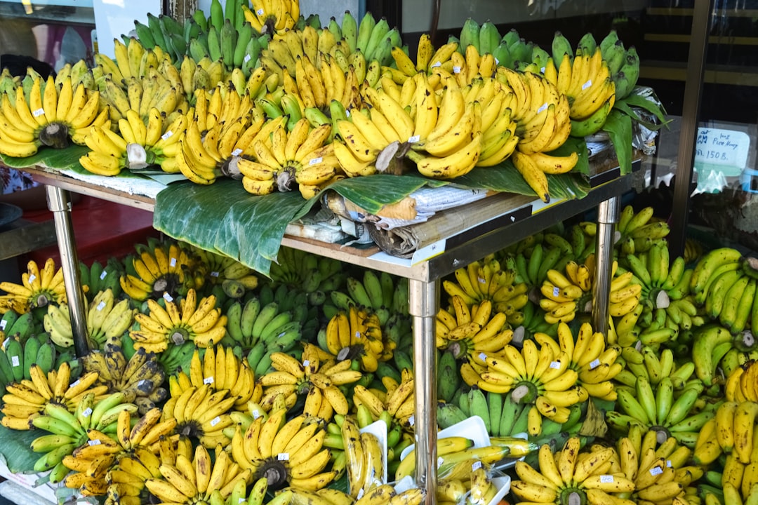 yellow banana fruits on black wooden table