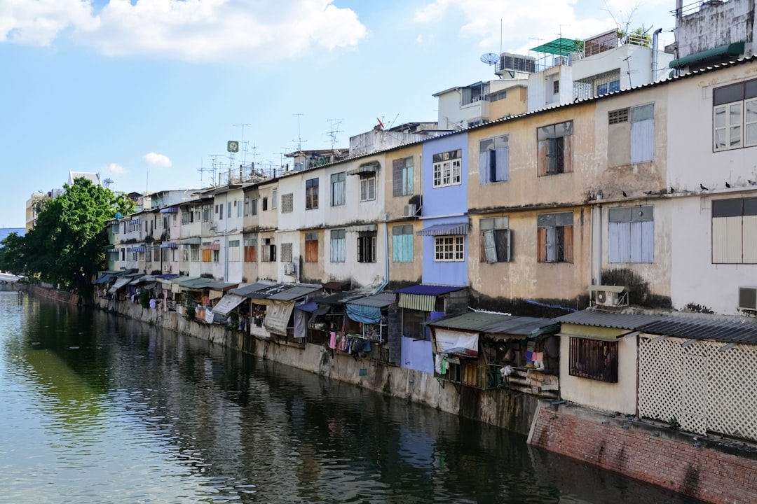 white and brown concrete building beside river during daytime