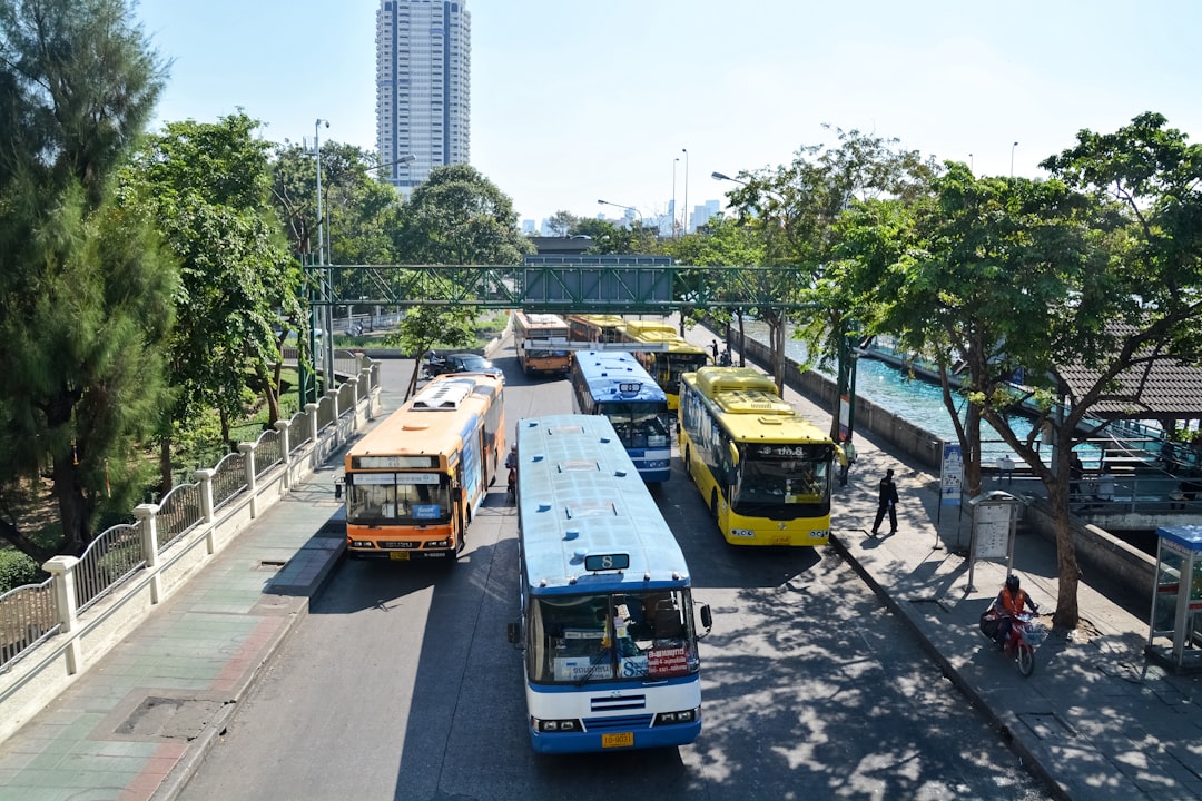 blue and yellow bus on road during daytime