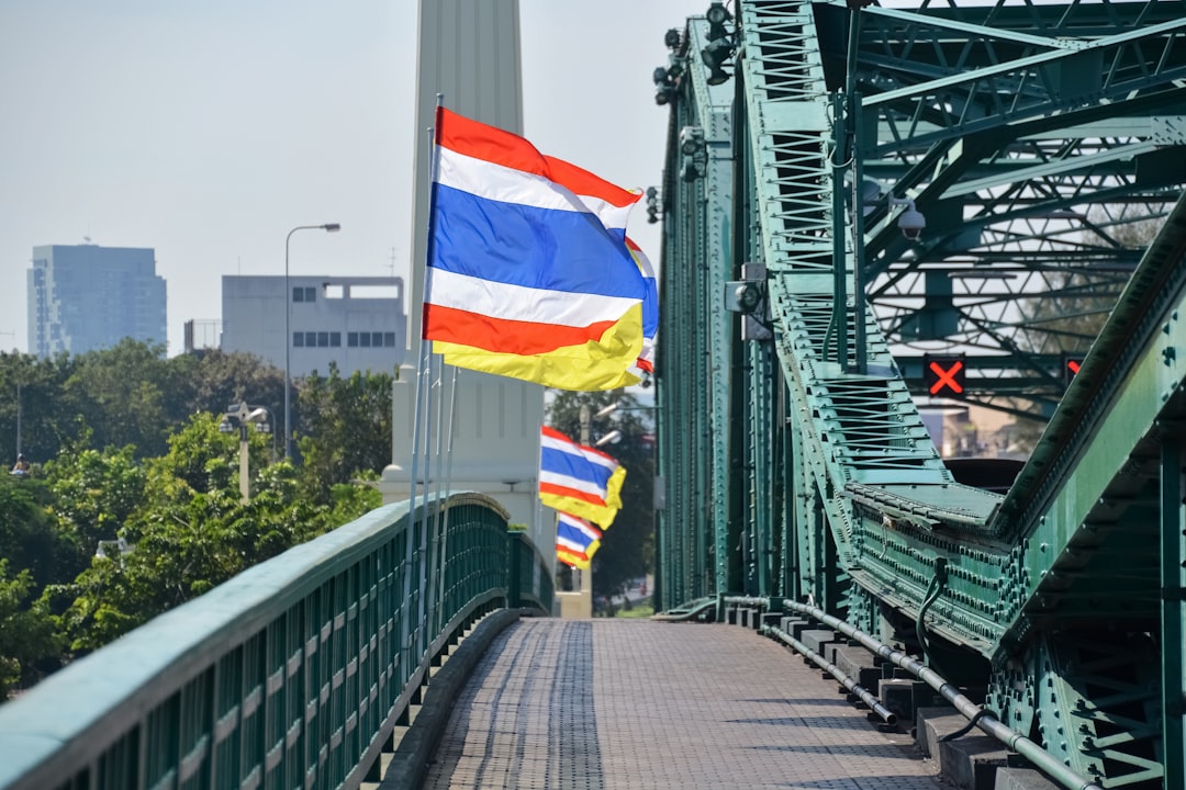 flag of us a on gray metal bridge