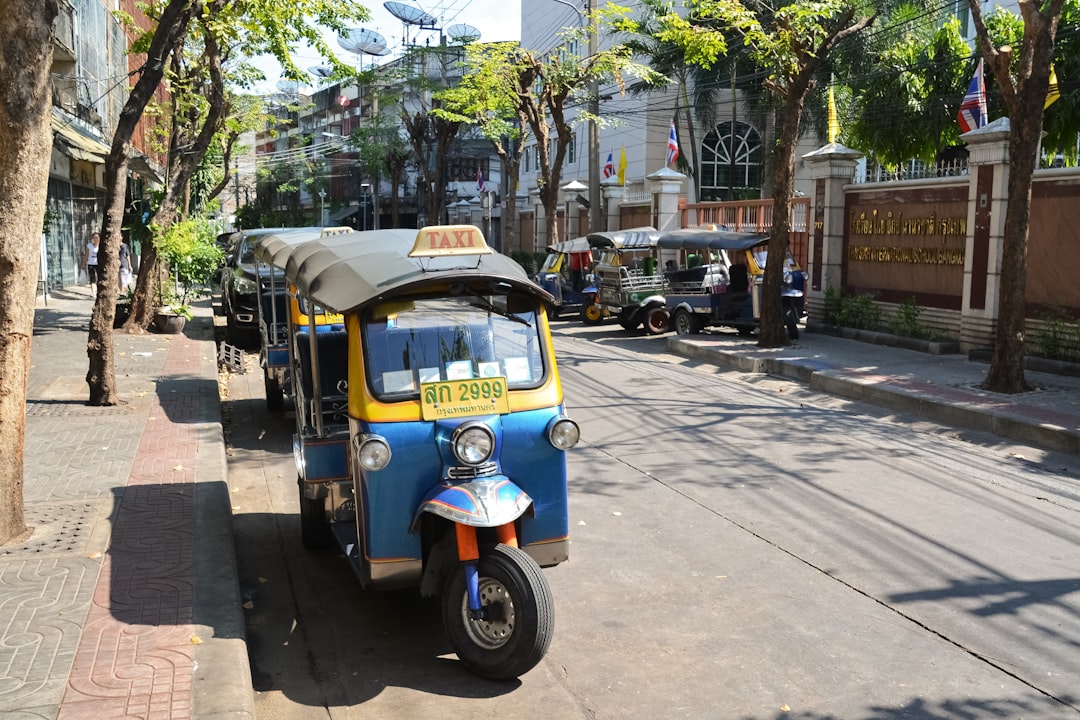 blue and yellow auto rickshaw on road during daytime