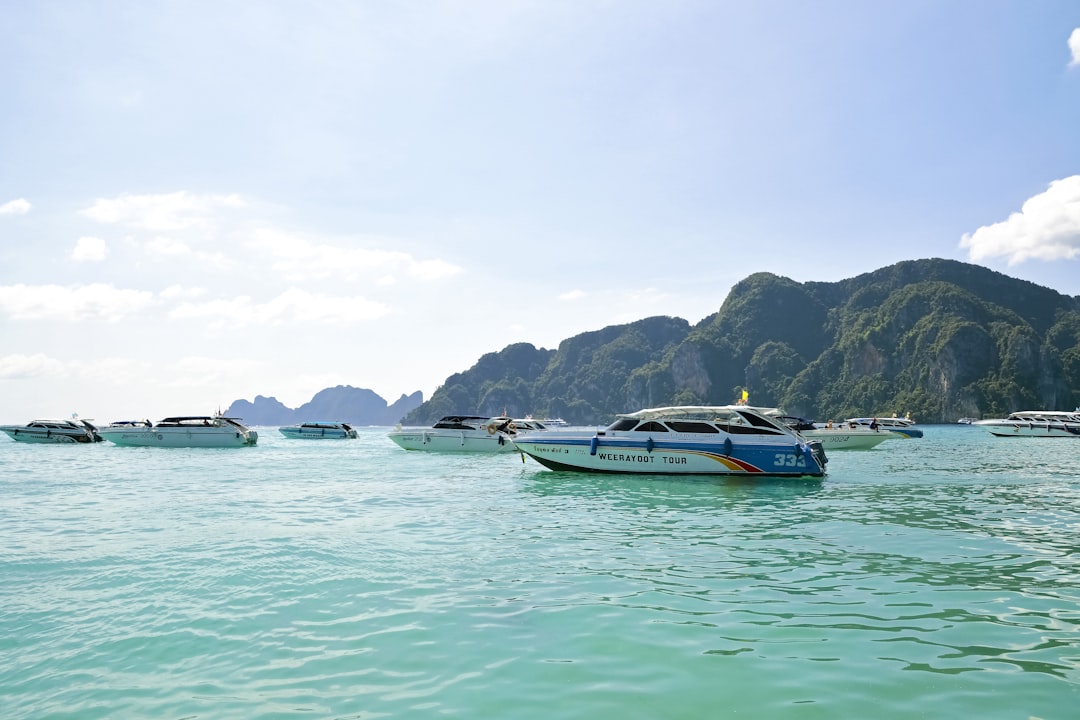 white and blue boat on sea during daytime