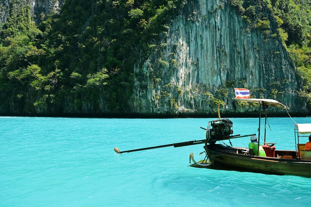 man in black shirt riding on boat on body of water during daytime