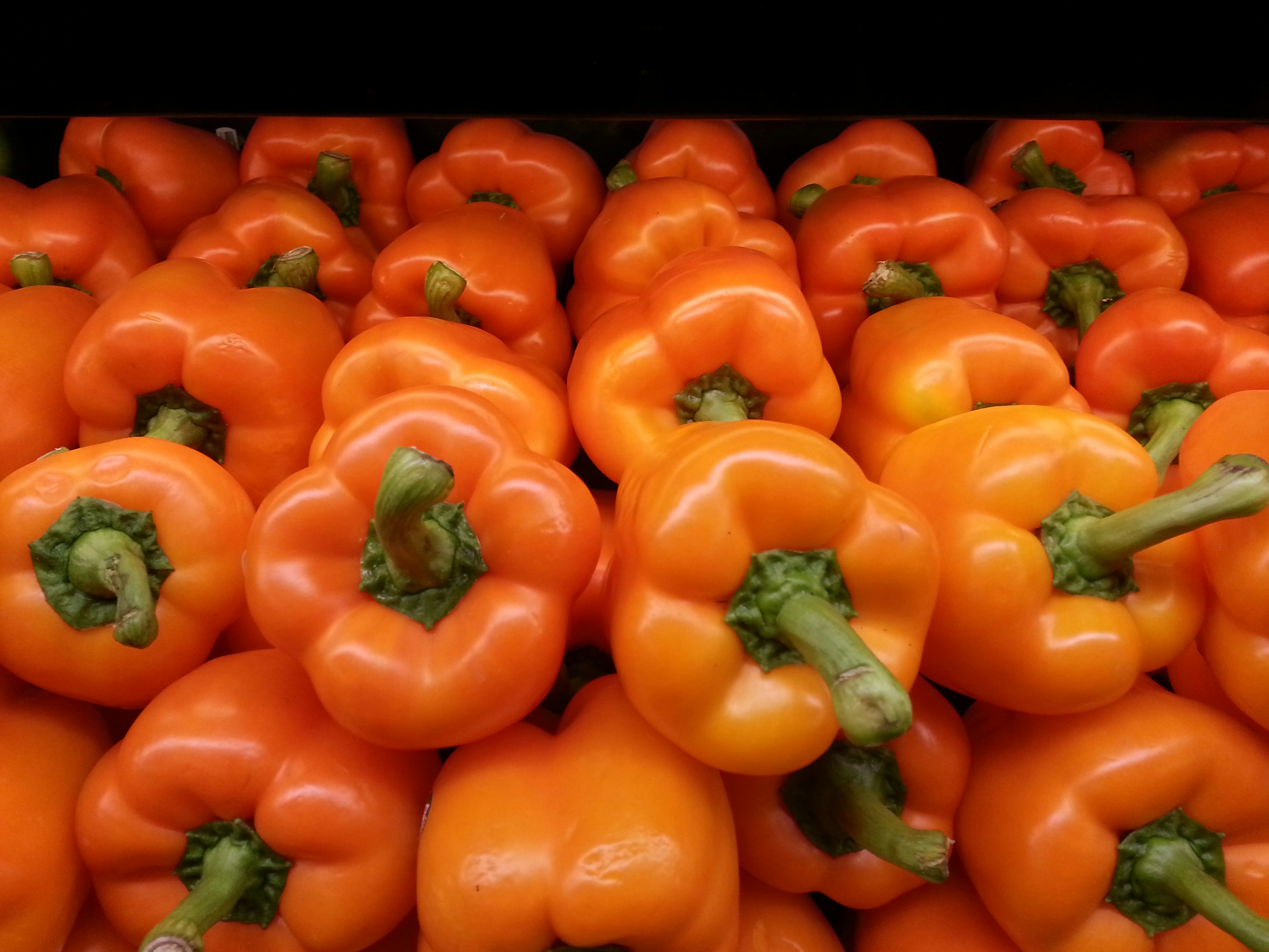red bell pepper on brown wooden table