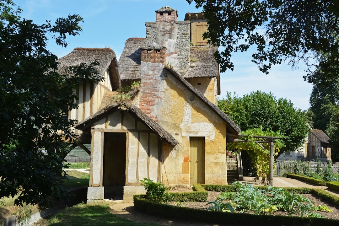 brown concrete house near green trees during daytime