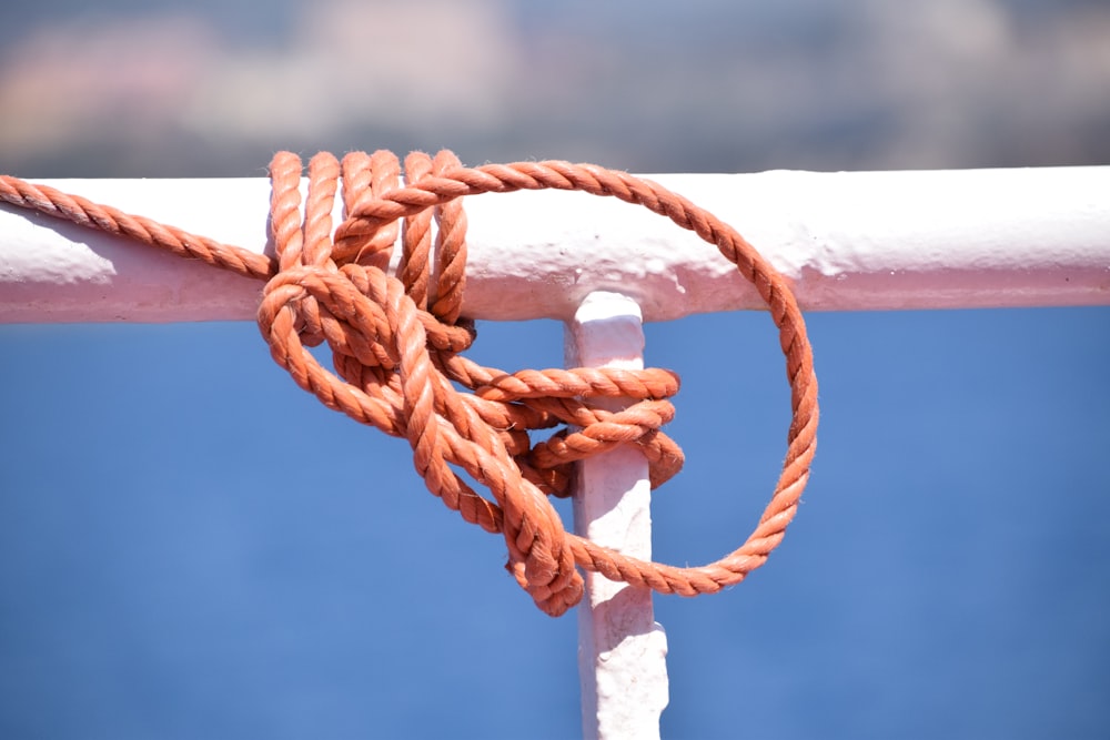 brown rope tied on white metal bar