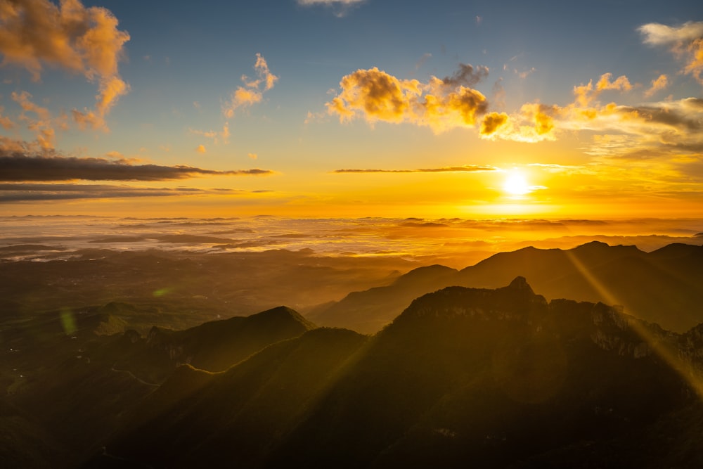 silhouette of mountains under blue sky during daytime