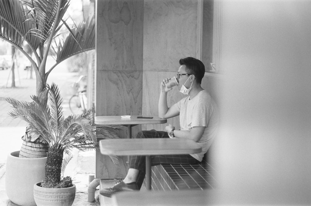 man in white dress shirt sitting on chair