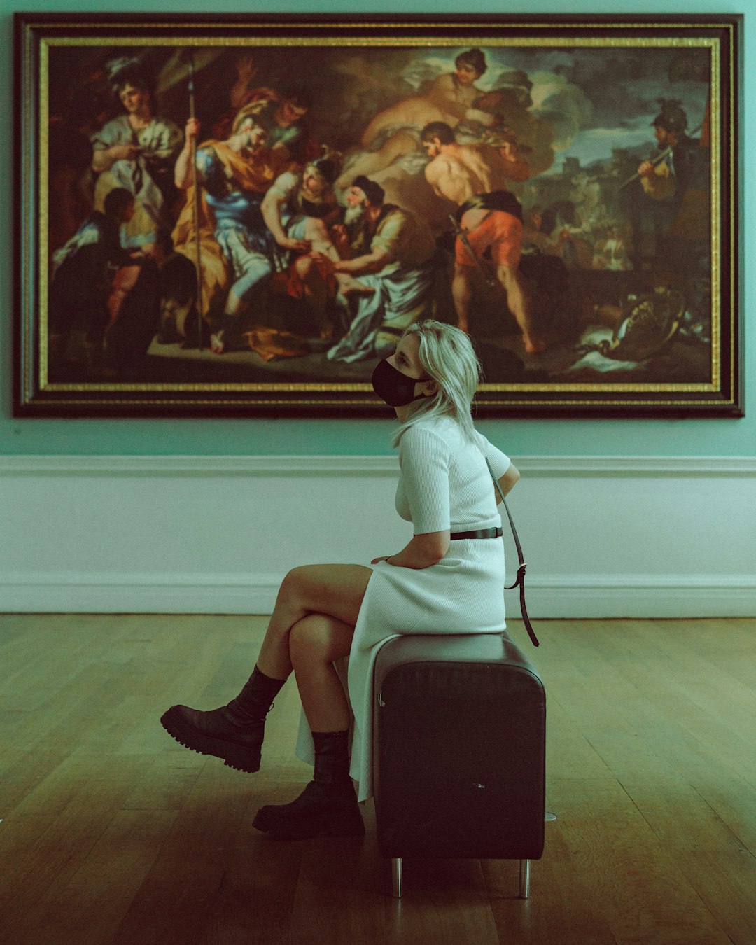 woman in white dress sitting on black chair