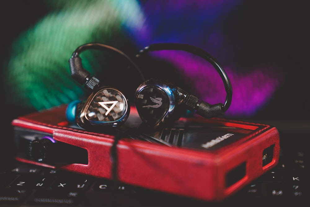 black and red headphones on red and black electronic device