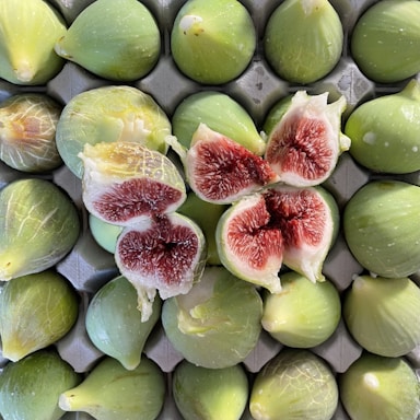 green and red fruit in close up photography