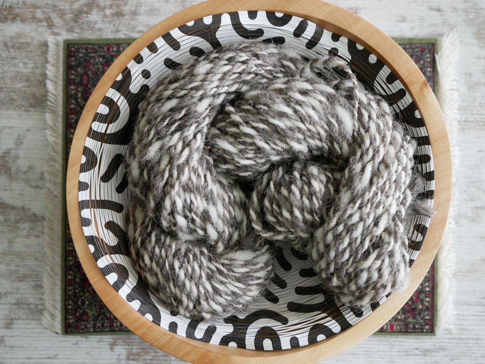 gray yarn on blue and white ceramic bowl