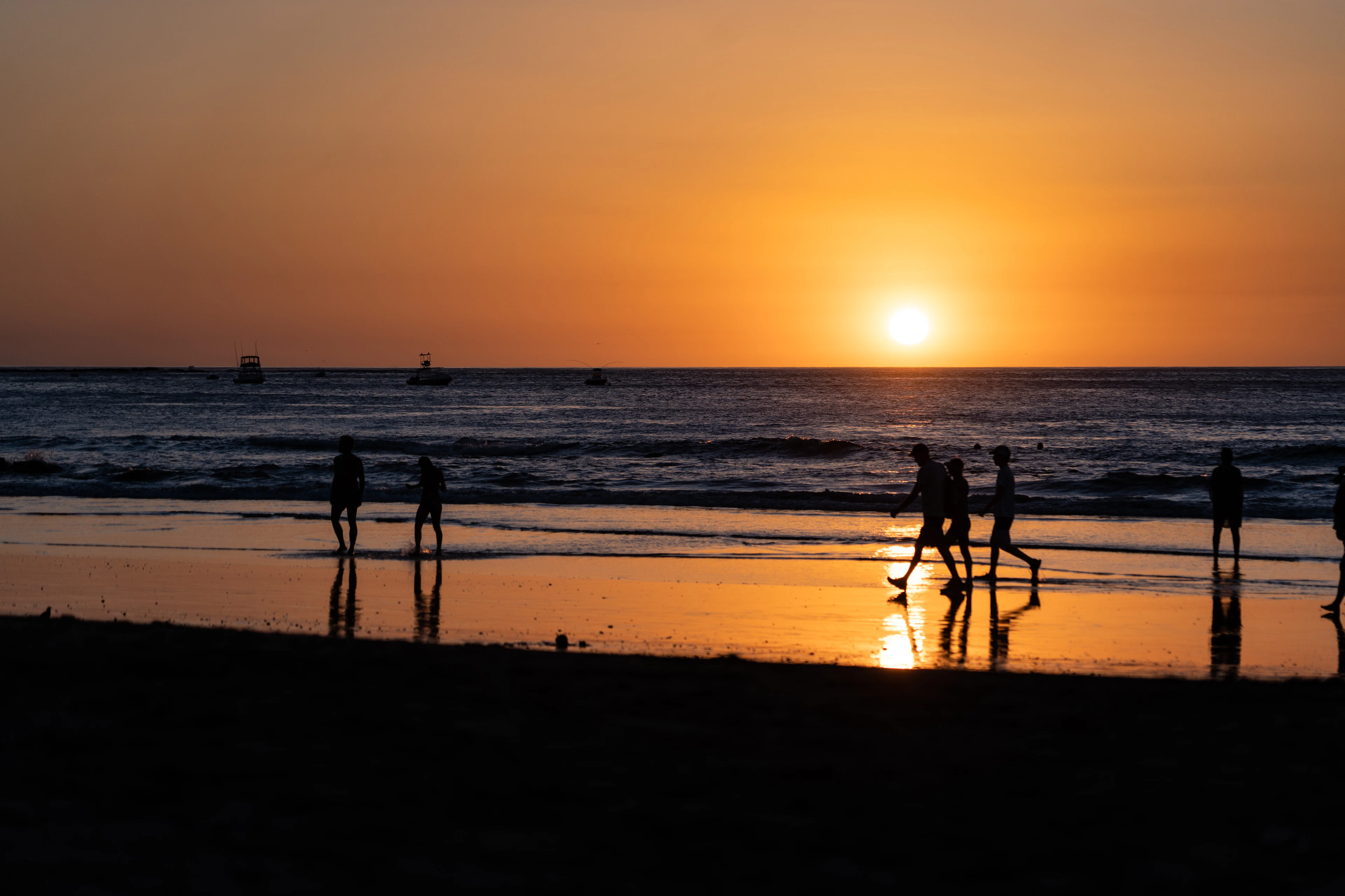 Figures silhouetted on the beach as the sun sets over the Pacific, Guanacaste