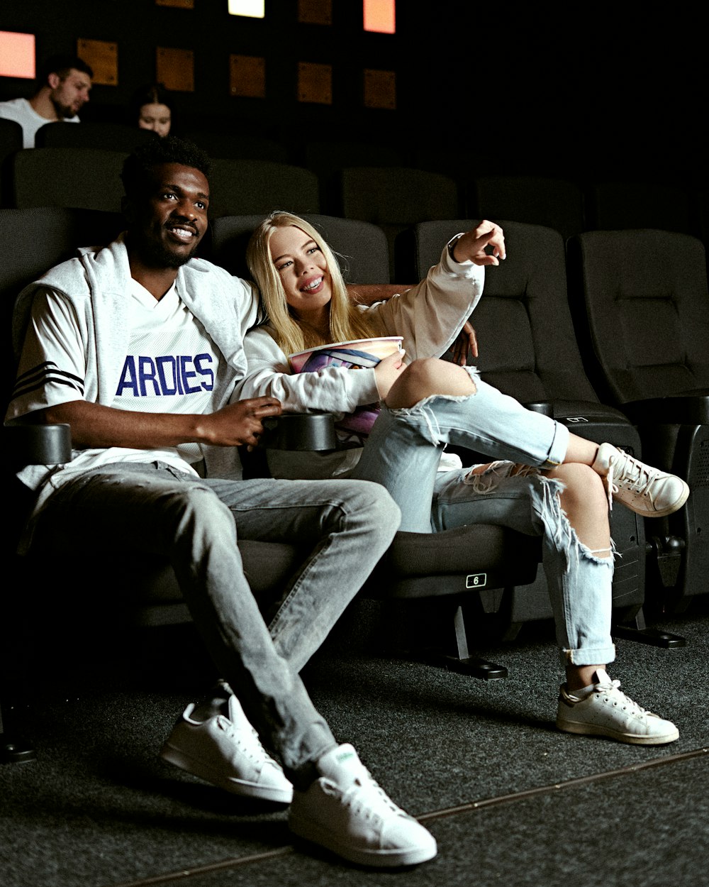 man in blue and white crew neck t-shirt sitting beside woman in white crew neck