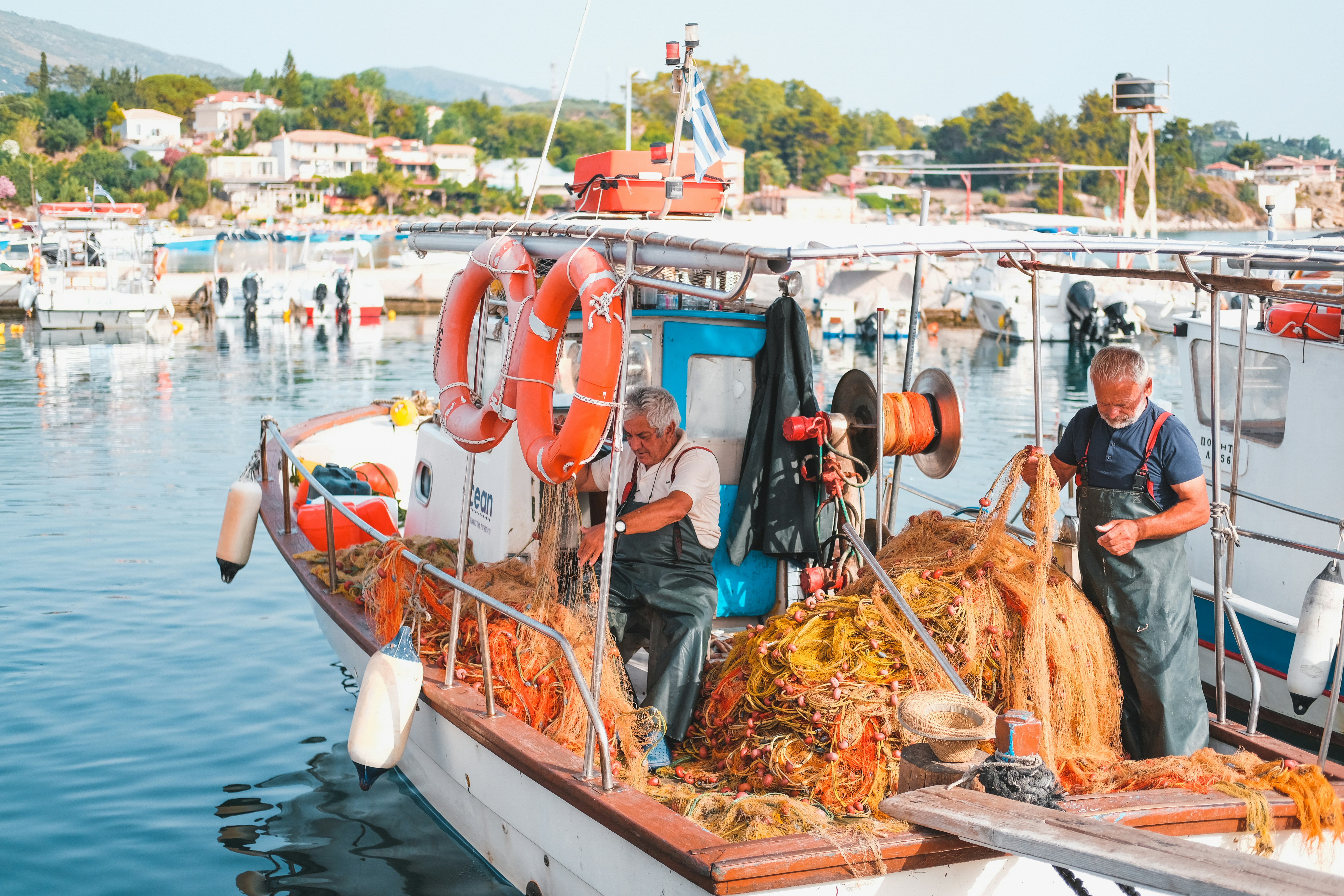 man in blue jacket standing on boat during daytime