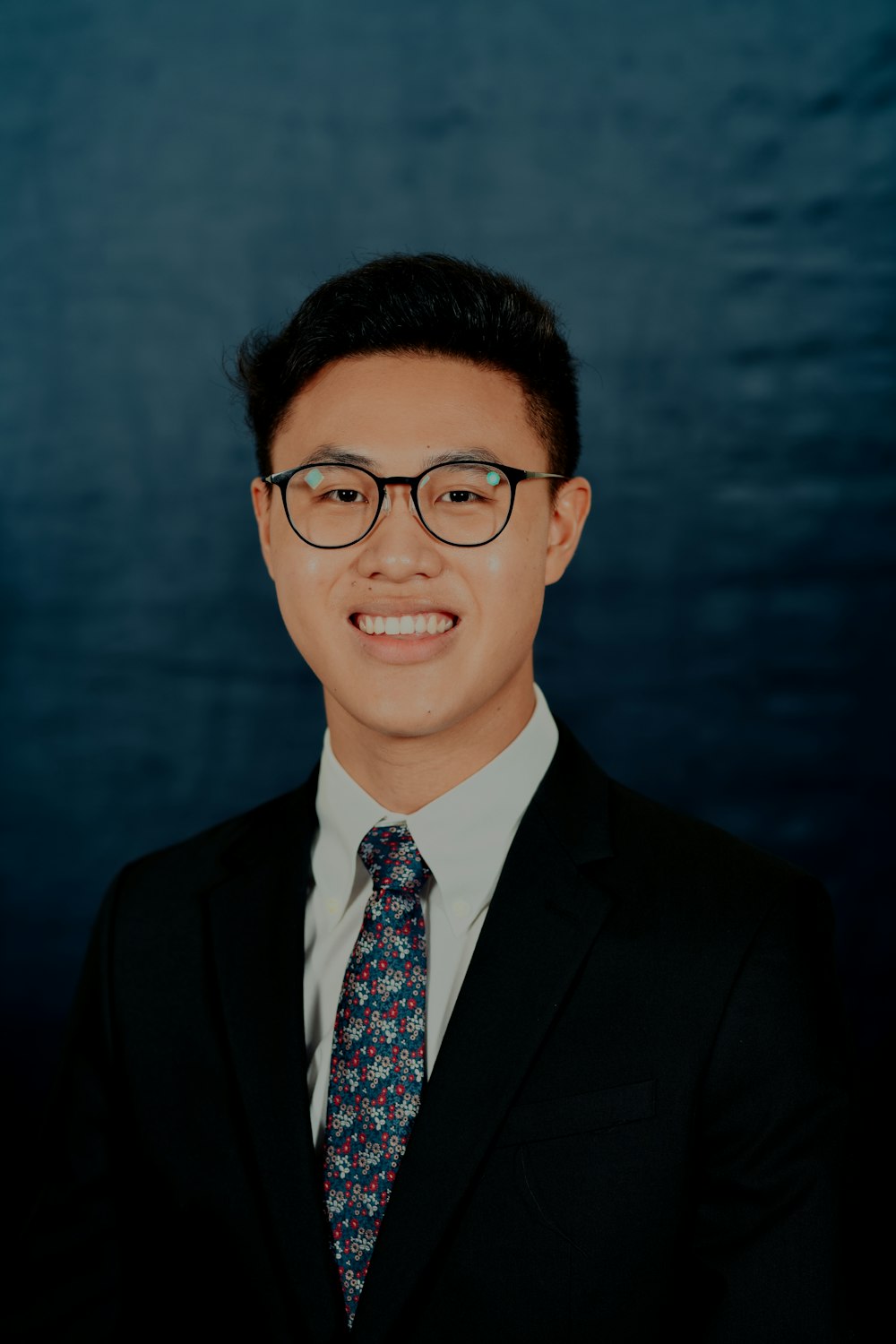 man in black suit wearing eyeglasses