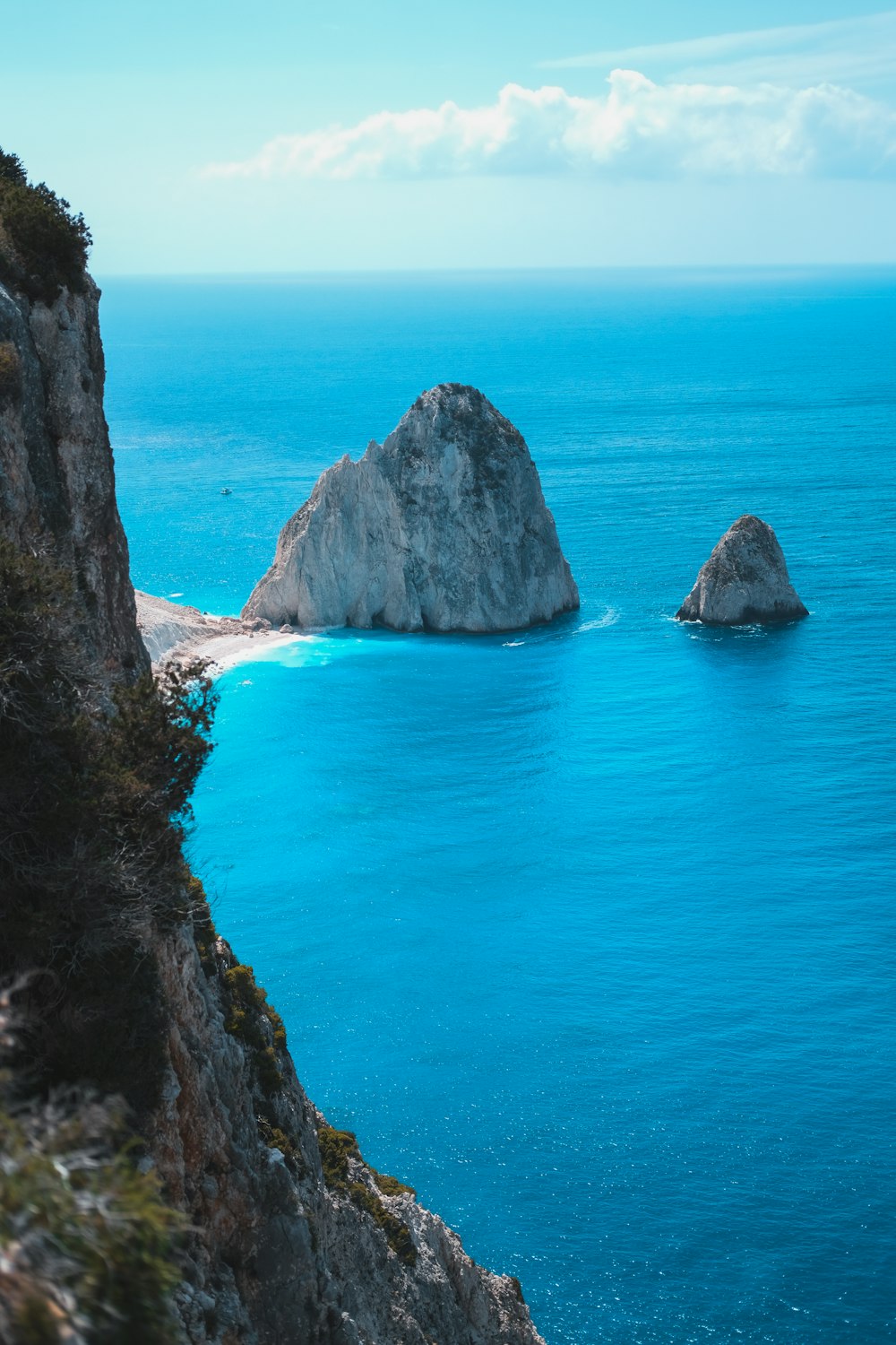 brown rock formation on blue sea water during daytime