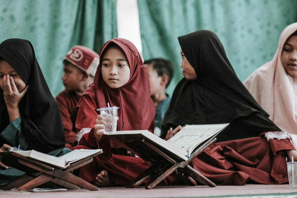 woman in red hijab sitting on chair