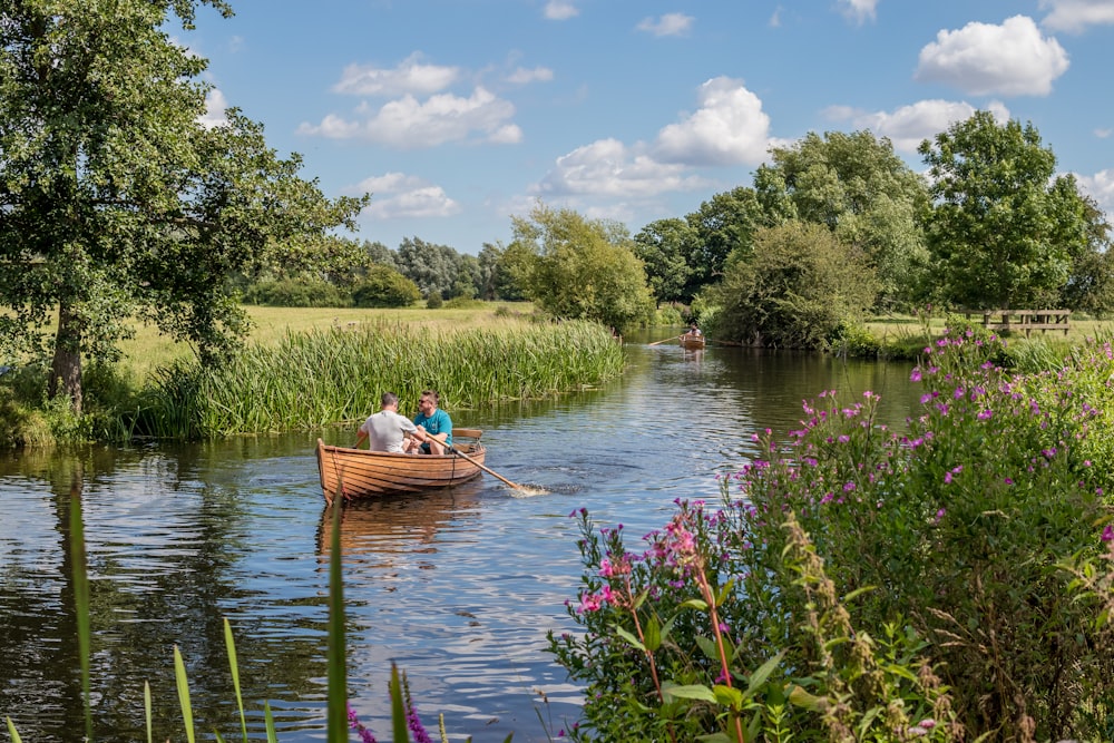 people riding boat on river during daytime