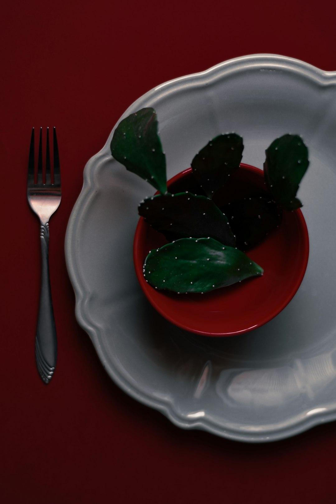 red tomato on white ceramic plate