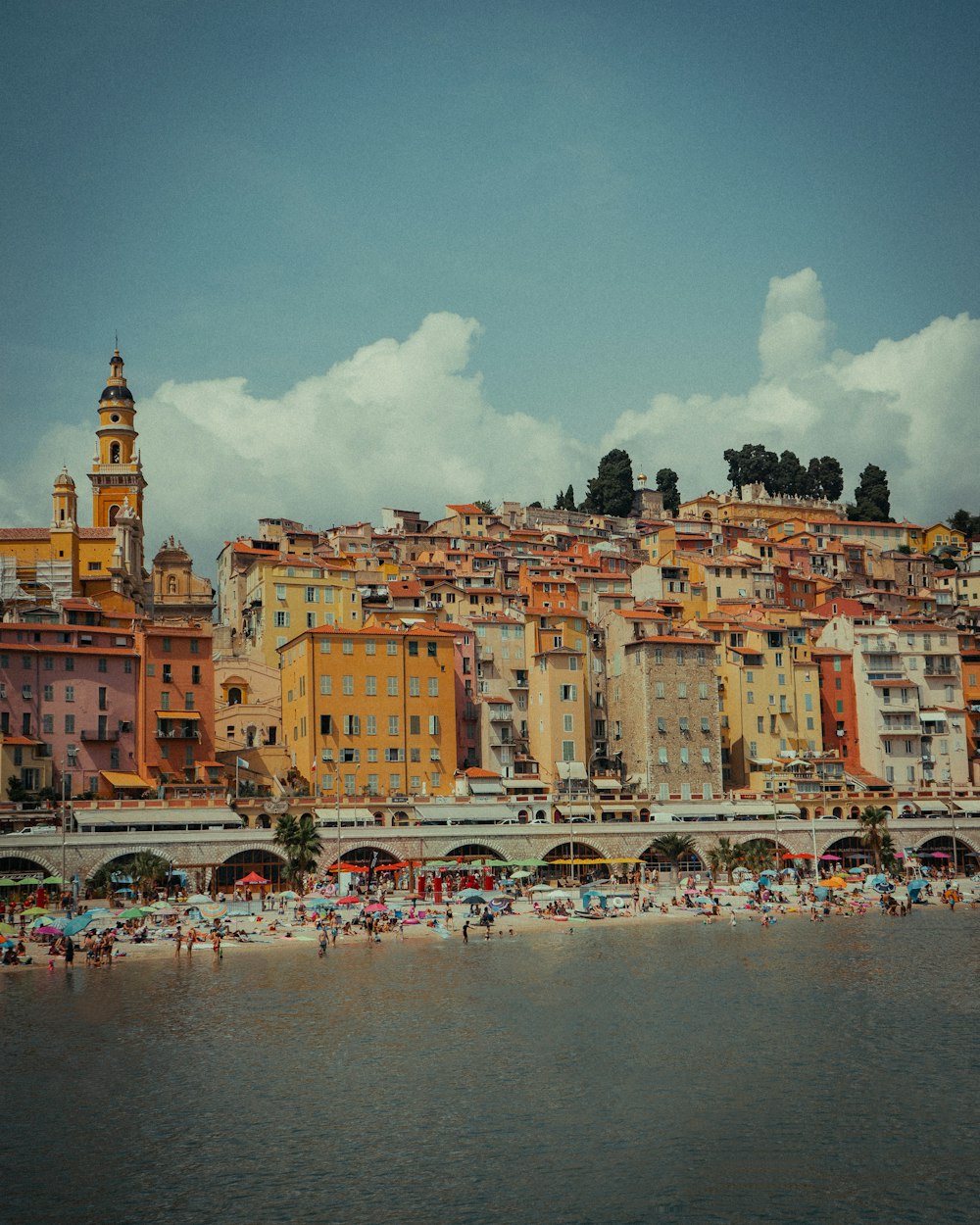 people on beach near buildings during daytime