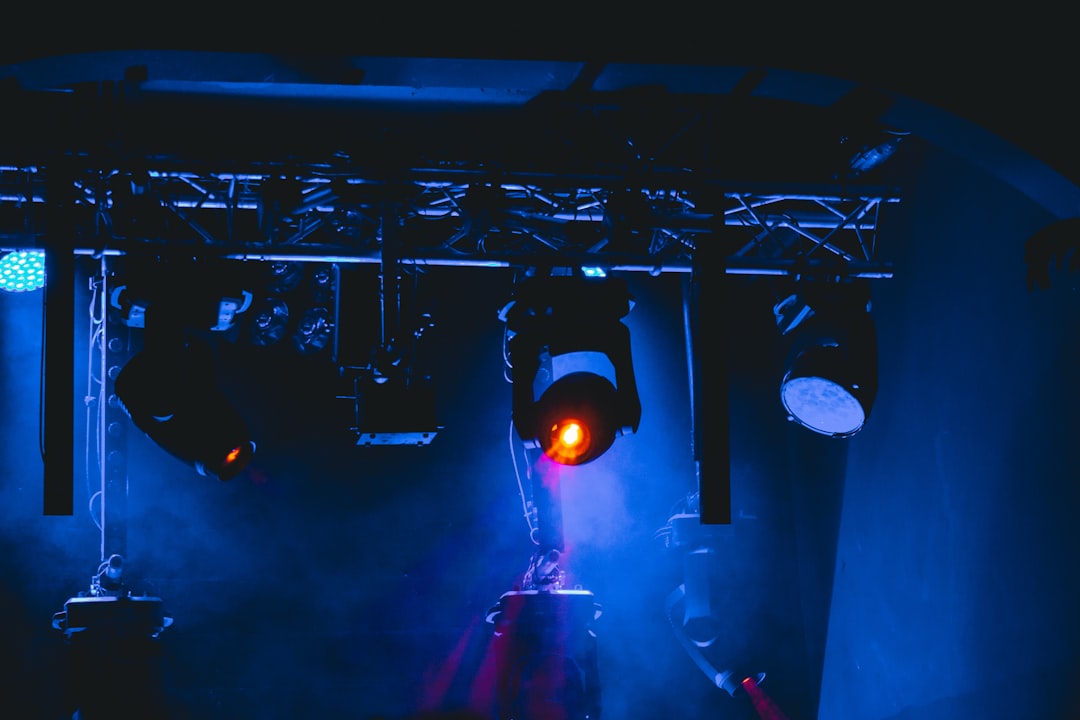 man in black shirt standing on stage