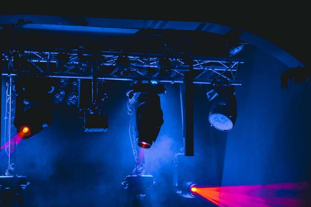 man in black jacket and pants standing on stage