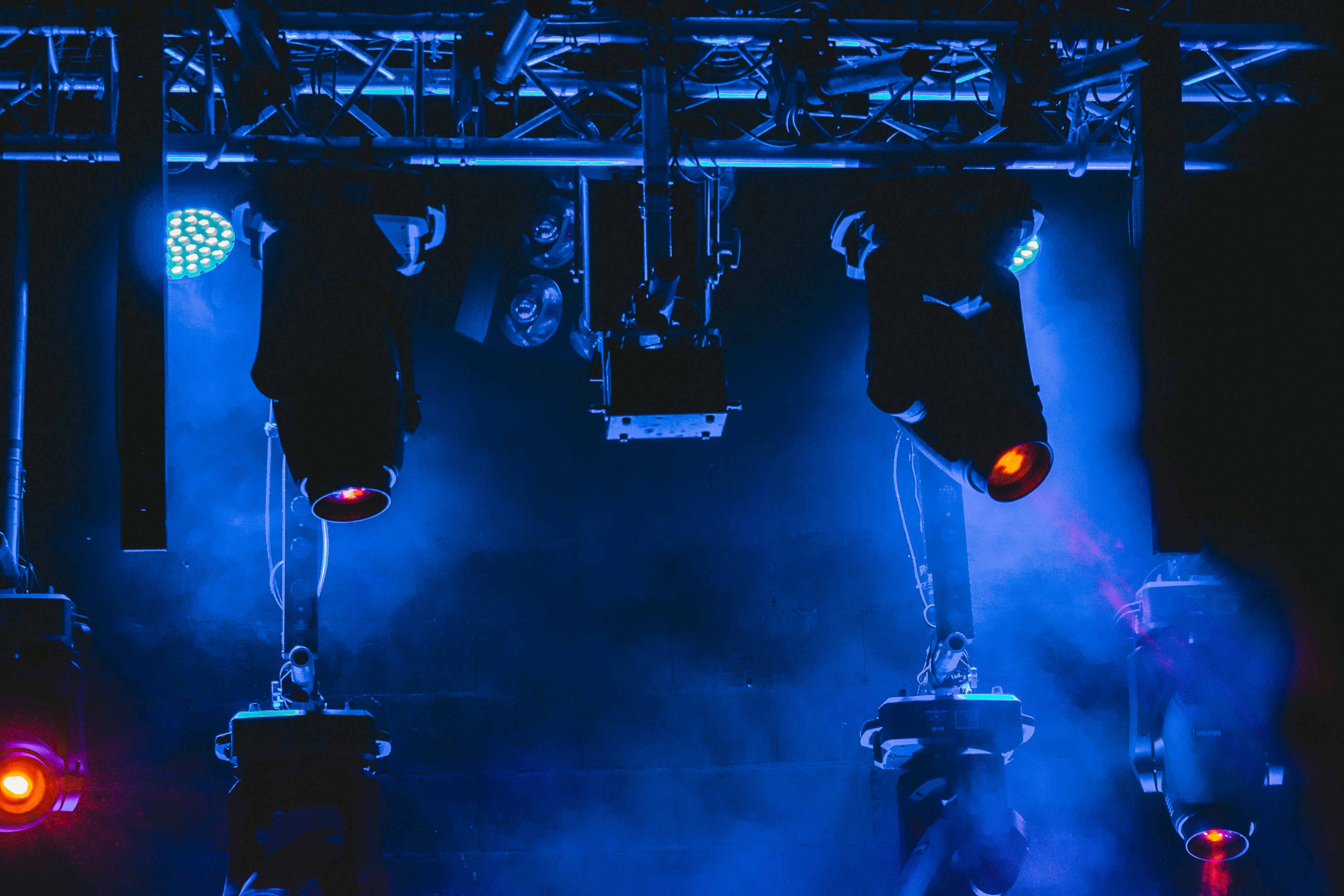man in black jacket and black pants standing on black metal frame
