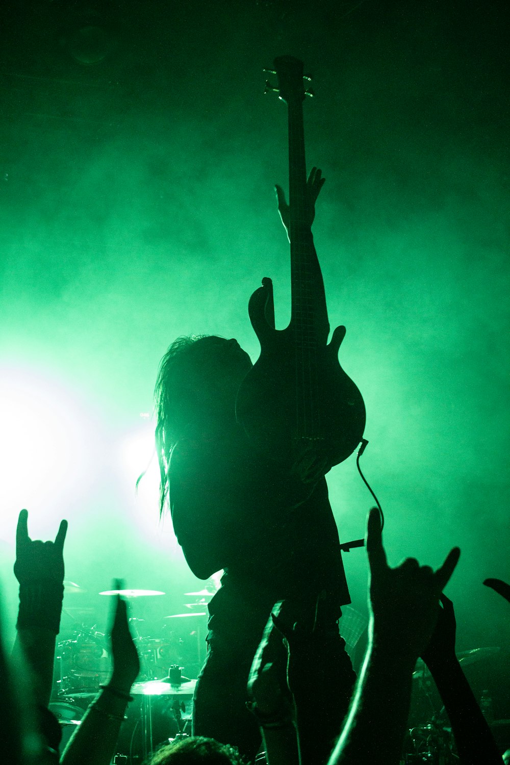 silhouette of people raising hands