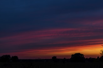 A colorful landscape canvas depicting a sunset.