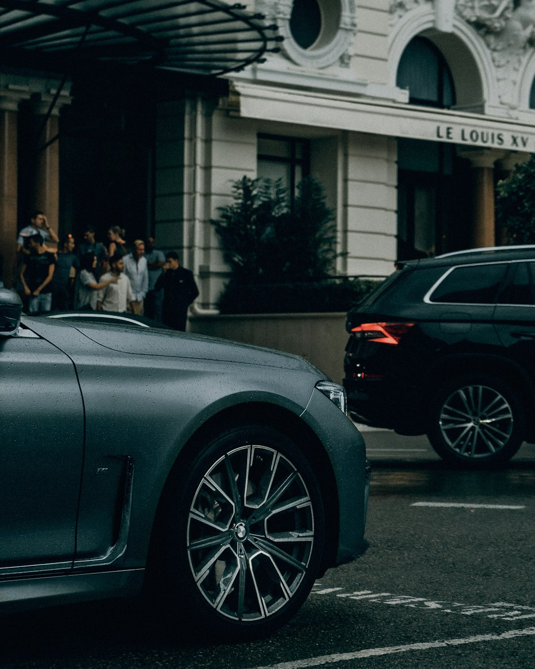 people standing beside black car during daytime