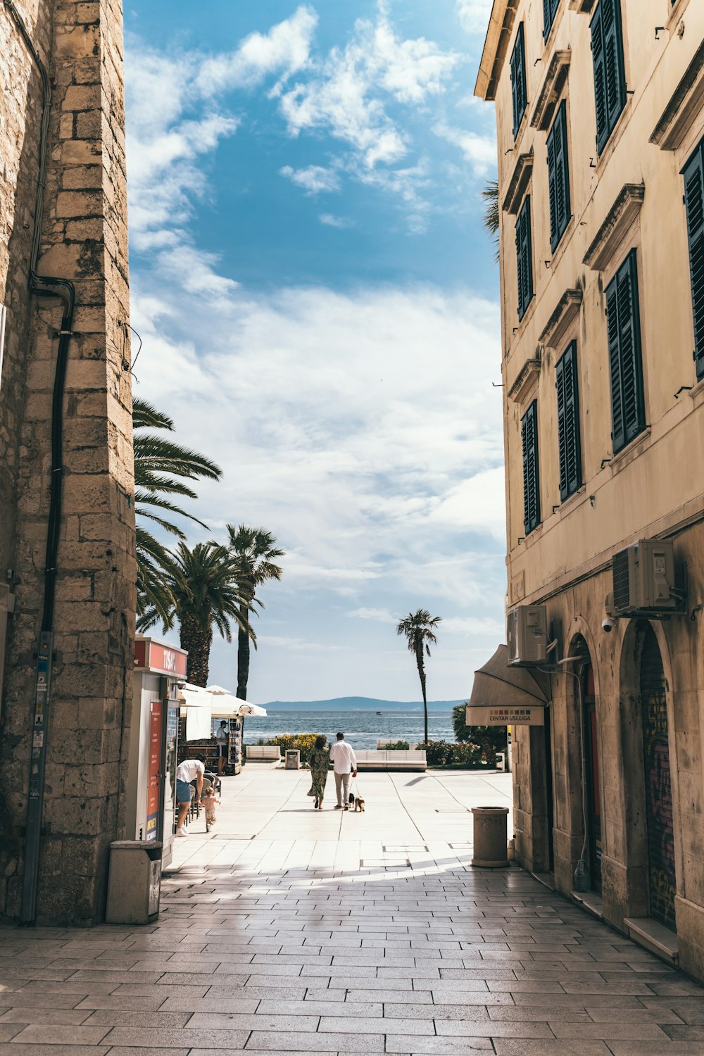 people walking on street near brown concrete building during daytime