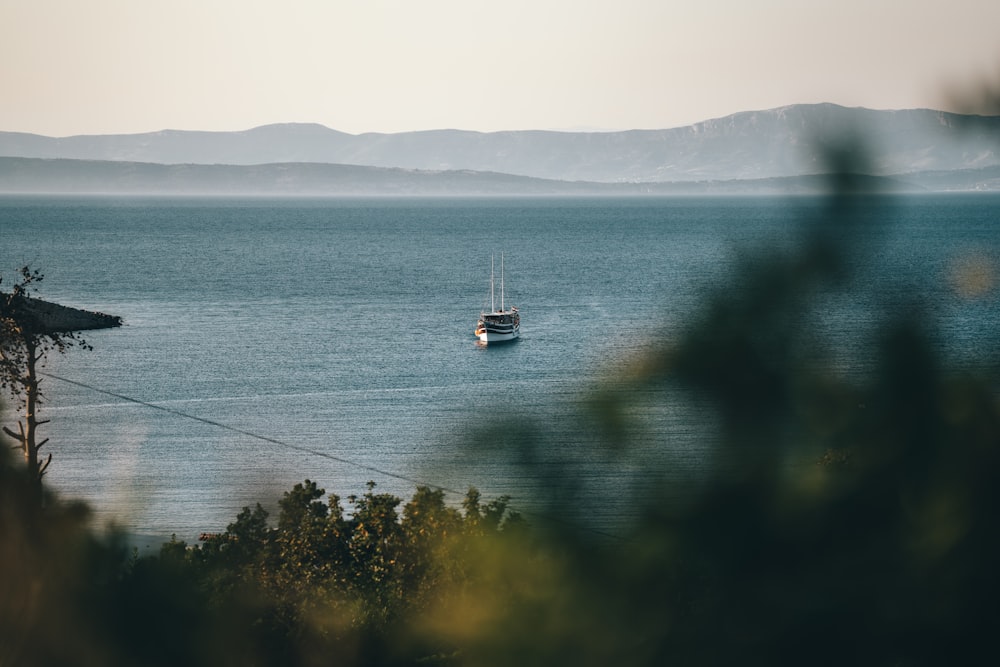 white boat on body of water during daytime