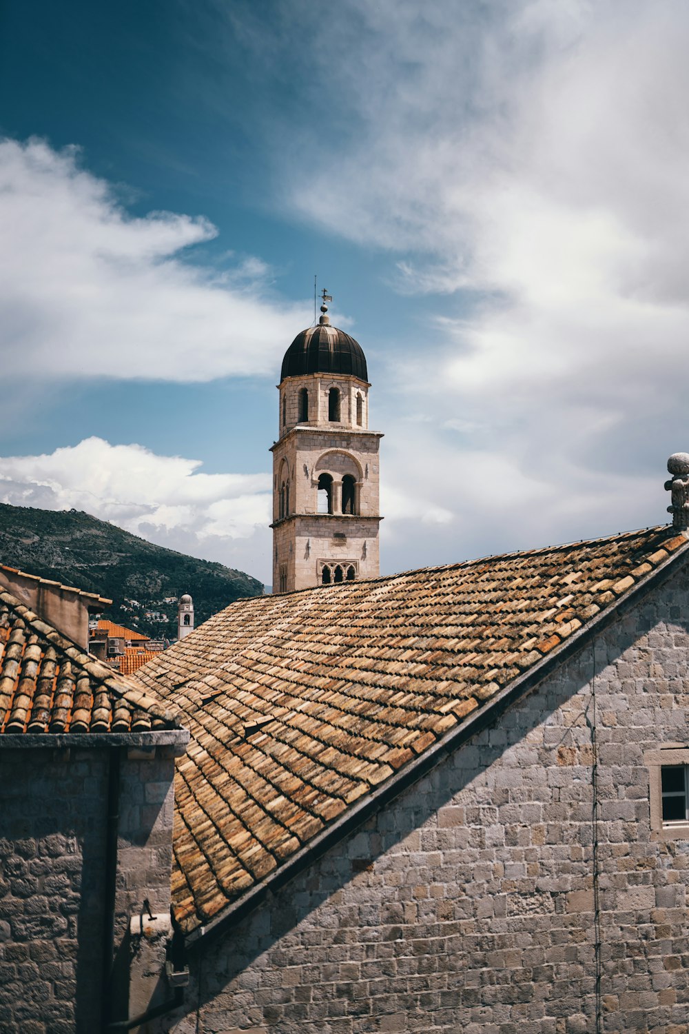 brown brick building under white clouds during daytime