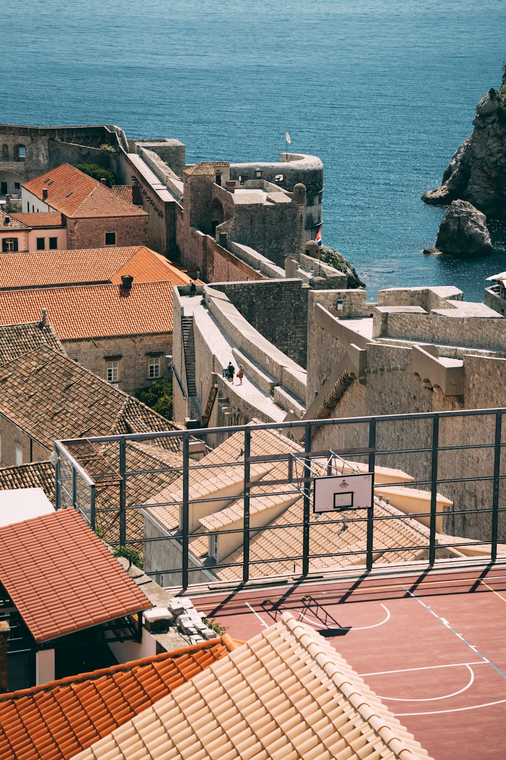 brown and white concrete houses near sea during daytime